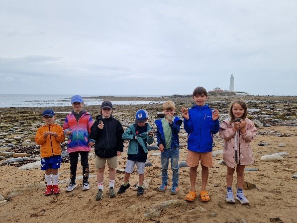 A group of children standing in front of St Mary's island 