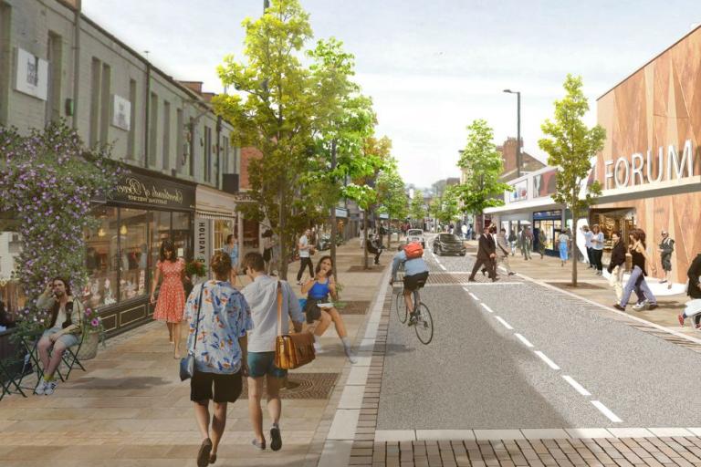 An artists impression of Station Road with people milling around enjoying the space, pedestrians on the footpath, a cyclist, the Forum Shopping centre and trees