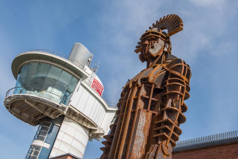 A colour photo of a sculpture of a Roman centurion outside Segedunum Roman Fort in Wallsend