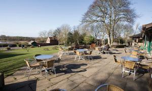 Outdoor seating on a patio looking over a park